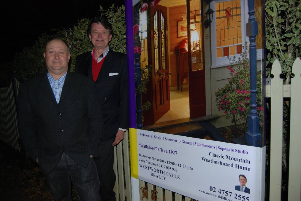 Jason Paul and John Chapman beside the glowing for sale sign at Wentworth Falls.