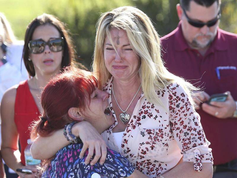 Parents wait for news after reports of a shooting at Marjory Stoneman High School in Florida.