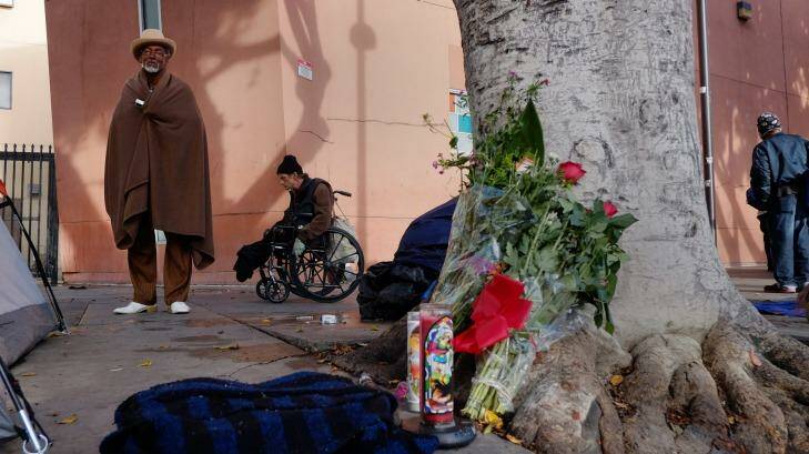 Ceola Waddell, 58, a homeless man who says he witnessed the police shooting on Sunday, stands by a memorial for the victim in downtown Los Angeles. Photo: Richard Vogel