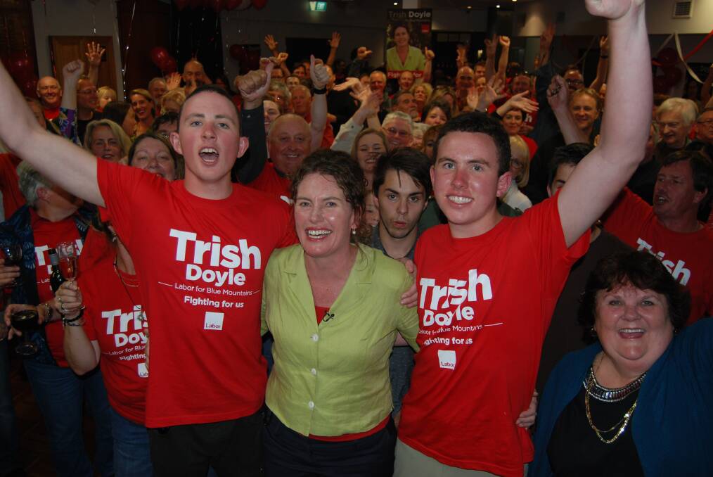New member for Blue Mountains, Trish Doyle, with her sons Patrick and Tom on election night.