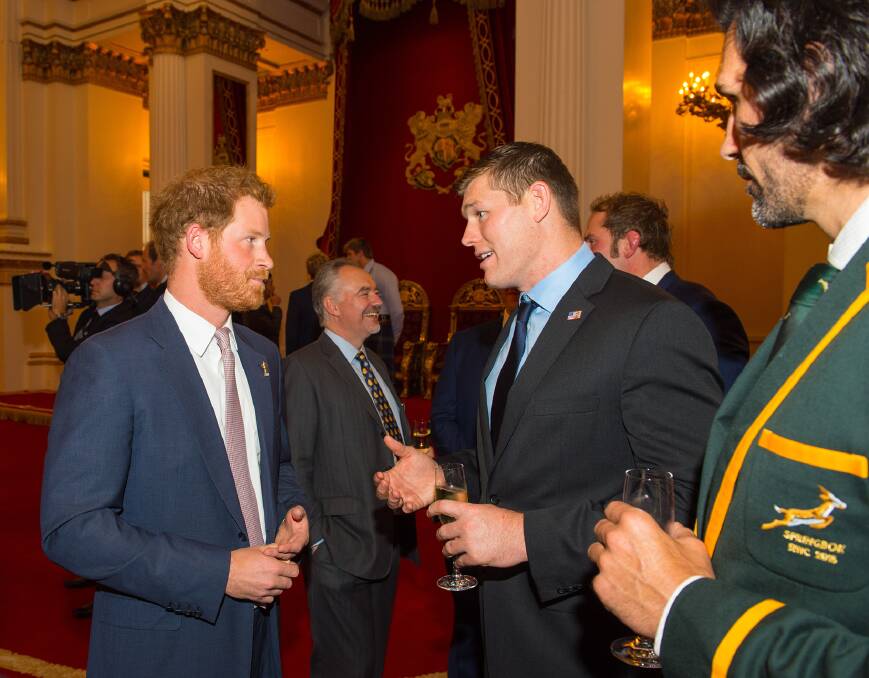 Royal meet: Prince Harry chats with Hayden Smith alongside Springbok Victor Matfield at a Rugby World Cup reception at Buckingham Palace on October 12. Photo: Dominic Lipinski/WPA Pool via Getty Images.