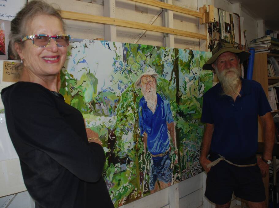Jennifer Gabbay stands in front of her artwork of Phil Foster as the real Phil Foster looks on.