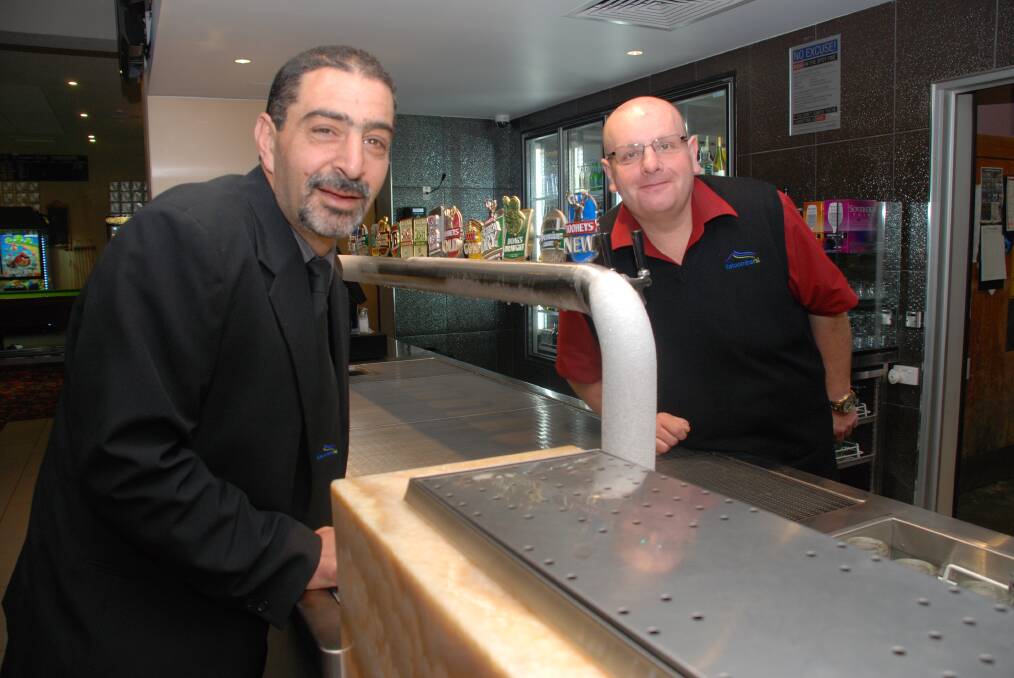 NOVA client Paul Cheetham gets a turn behind the bar, serving up his employer, Katoomba RSL CEO Nick Darias (left), as part of the 100 Jobs in 100 days campaign.