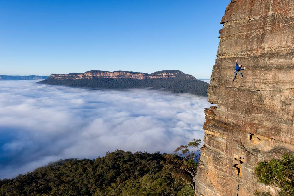 John Smoothy making the most of an early start for this grade 21 face climb in the Blue Mountains. Photo: Simon Carter.