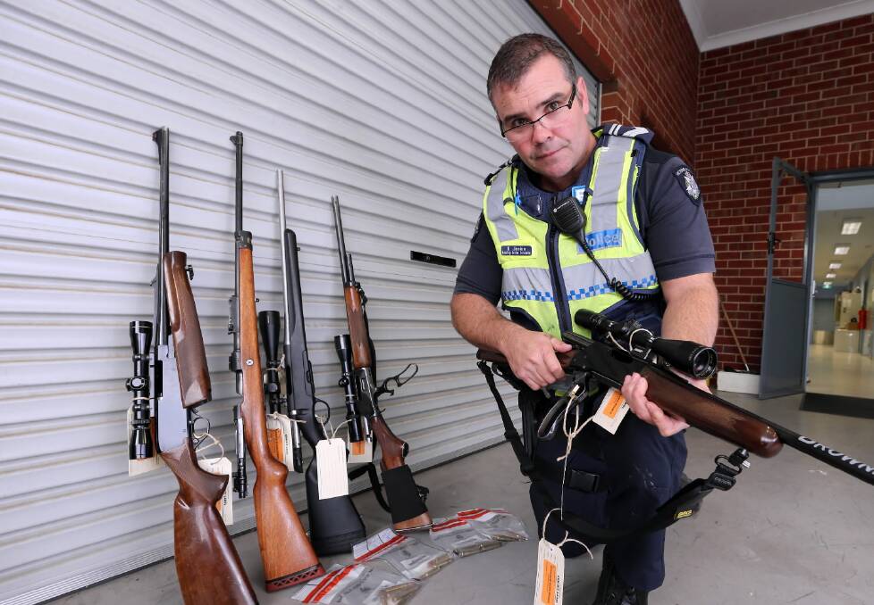 Myrtleford policeman Dave Jenkins with guns and ammunition seized from deer hunters at the weekend. Pic: Peter Merkesteyn