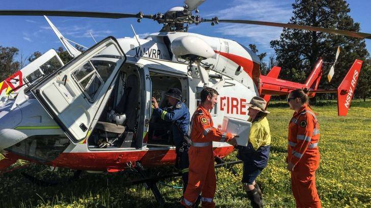 NSW SES volunteers deliver food and supplies to the Alcorn family on their property in Jemalong Photo:  John Townsend