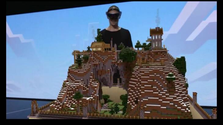 A representative from Minecraft developer Mojang shows off the HoloLens version of the game, which lets you place the 3D world on any flat surface and interact with it using voice commands or your hands.