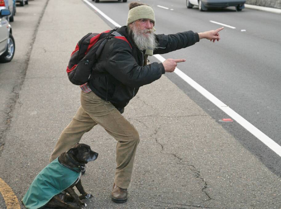 Peter Carroll and his trusty dog Aurora hitchhiking in Blaxland last decade. A memorial plaque will be installed in Lawson in his honour. Photo: David Darcy.