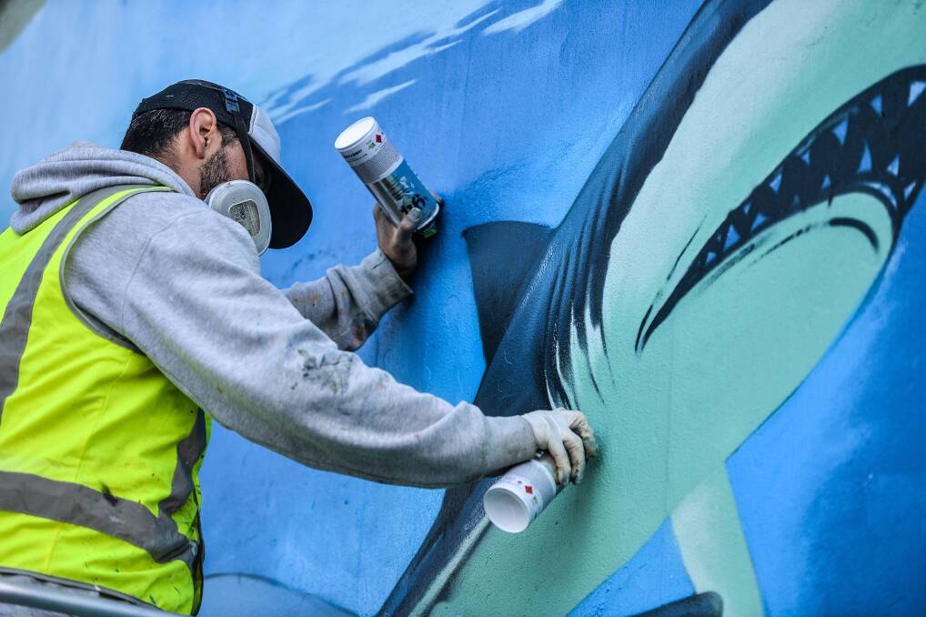 Mexican street artist Peque at work on the mural in Katoomba last week. Photo: Brigitte Grant Photography.