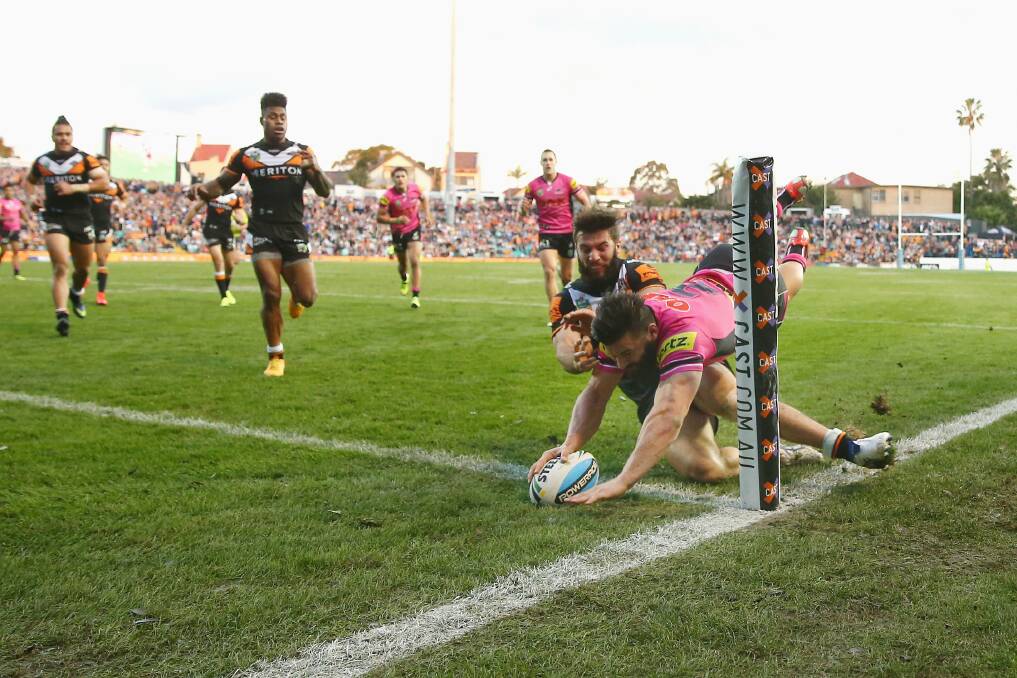 Comeback: Josh Mansour scores a try in his comeback match against the Wests Tigers on Sunday.  (Photo by Mark Kolbe/Getty Images)