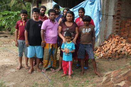 Mr Kuruppu (seen here in purple shirt) with his family and the families of Janaka Athukorala (in background with beard) and Sujeewa Saparamadu (second from right). Photo: Jason Koutsoukis