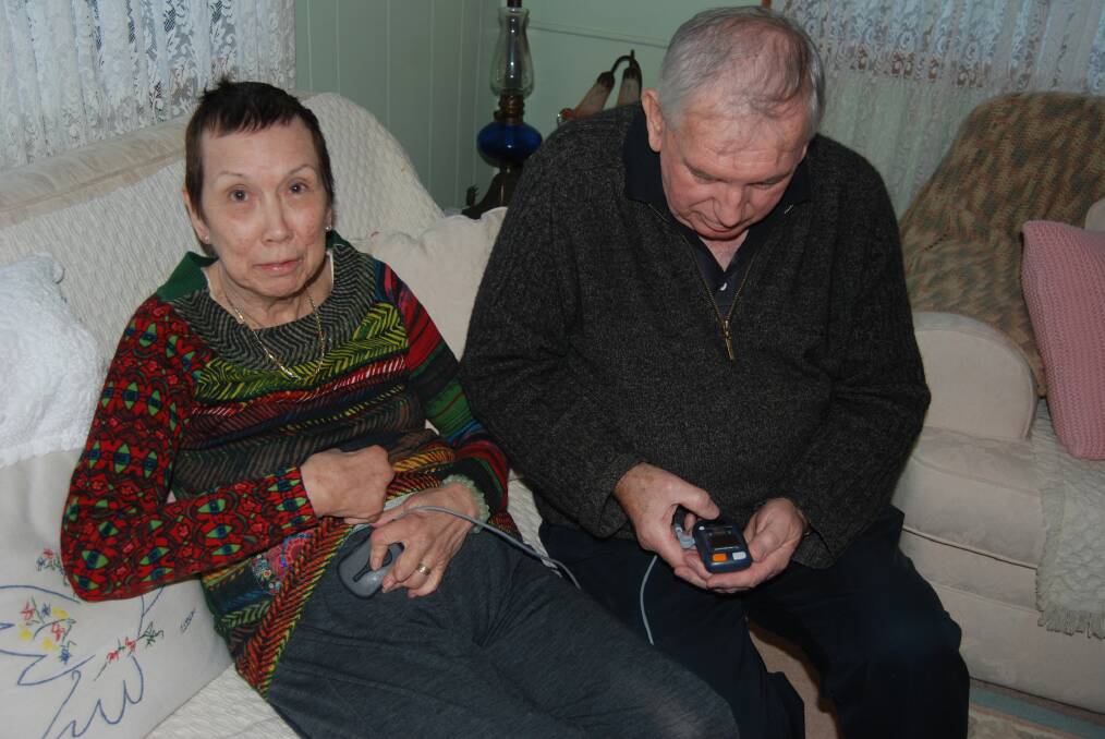 Robert O'Connor checks the readings on the device implanted into his wife Cecilia's stomach to alleviate the symptoms of Parkinson's disease.