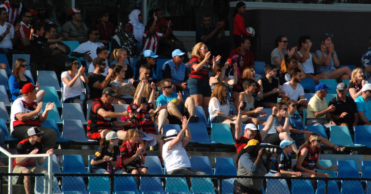 Wanderers fans celebrate their team's 2-1 W-League win against Sydney FC at Edensor Park on Sunday.