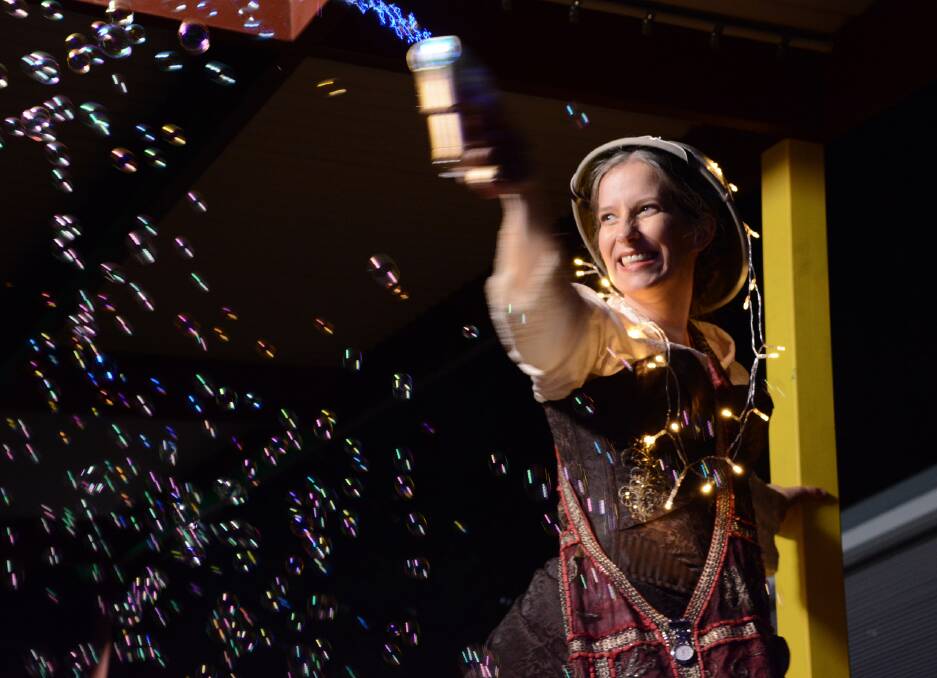 More bubbles, no troubles: Tall Miss Jilly fires another round of bubbles for all to catch at the Blaxland Public School Twilight Fete on May 16.