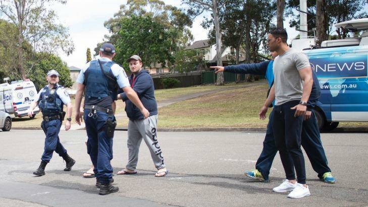 Relatives clash with police and media at the scene of Tuesday's fatal shooting in Georges Hall. Photo: Fairfax Media