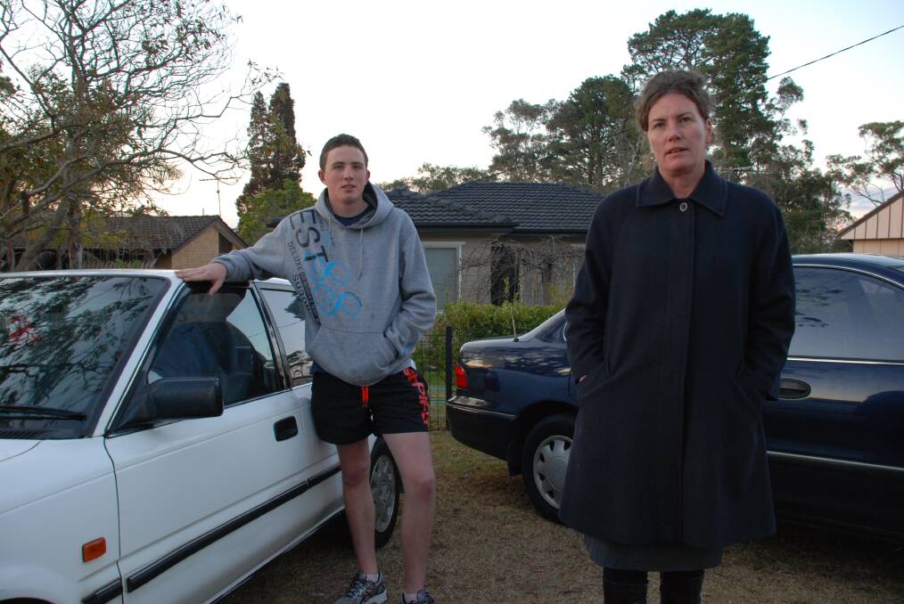 Labor candidate Trish Doyle with son Patrick, 17, and his recently purchased 1994 Toyota Corolla. The high school student saved for two years (working in a part-time job) to buy the car and helps his mum by driving his younger brother to Sydney music commitments. Ms Doyle is angry about the Treasurer's comments about poor people not needing cars  they rely on both vehicles.