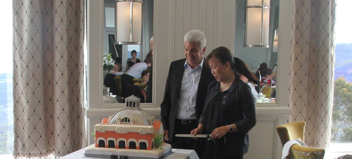 Owners of the Escarpment Group, George Saad and Huong Nguyen, with the specially-made Hydro cake.