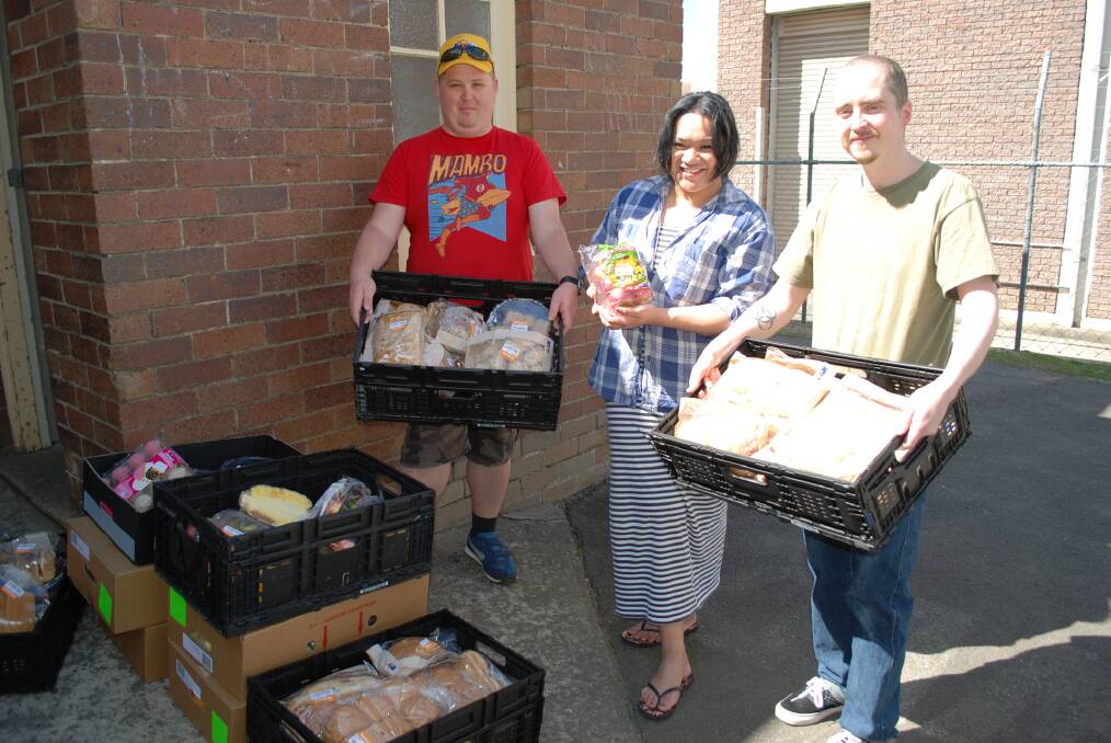 Volunteers Jeremy Bray, Caroline Tofa and Edward Dollin with some of the produce given to Food Rescue by Woolworths at Katoomba.