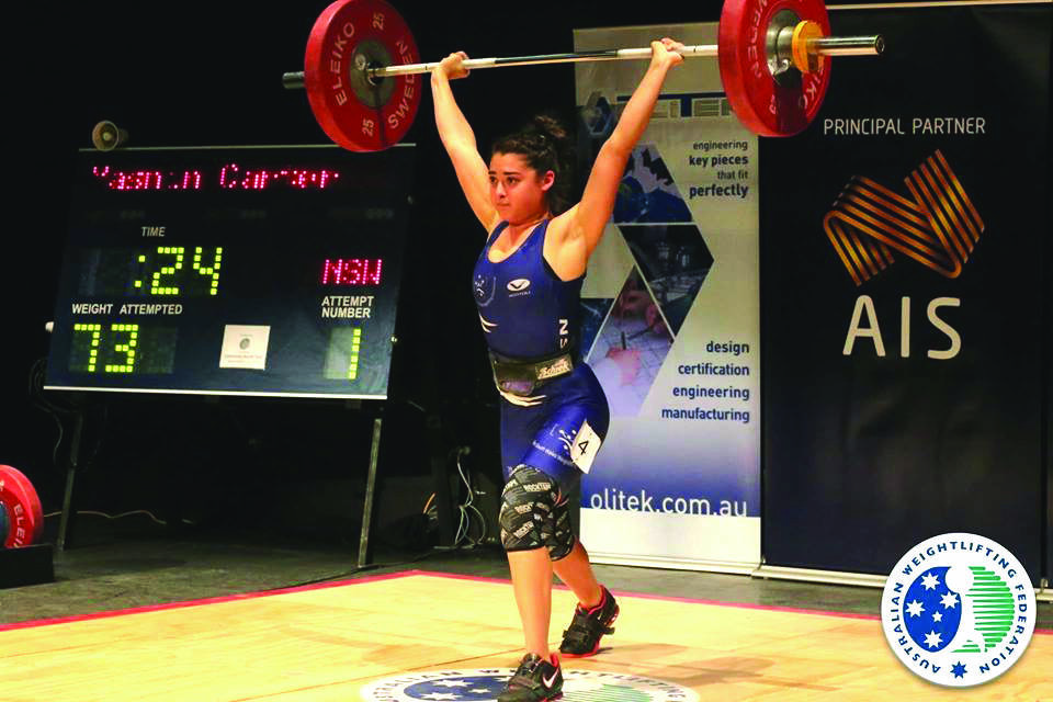 Winmalee native Yasmin Carter, 16, on her way to victory in the women's clean and jerk at the 2015 AWF National Youth Championships in June. She will now compete for Australia in weightlifting at the 2015 Youth Commonwealth Games in Samoa from September 5.