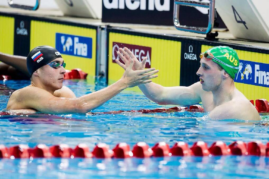 Springwood's Matthew Wilson congratulates gold medal winner in the 200m breaststroke final, Russian Anton Chupkov, at last month's World Junior Swimming Championships in Singapore. Wilson won silver after producing another personal best time.