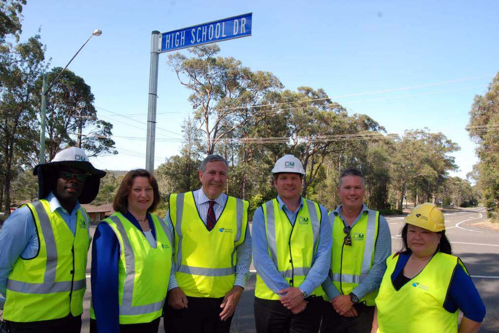 Member for Blue Mountains Roza Sage and NSW Roads Minister Duncan Gay (second and third from left) with staff from road building company Downer Mouchel (construction manager) Robert Semaganda, (program manager) Chris Gatehouse, (lead stakeholder consultant) Erik Sodergren and Roads and Maritime Services contractor relationship manager Liz Sim at Hawkesbury Road, Winmalee on Monday. Construction work began that night on a $2.1 million road resurfacing project.