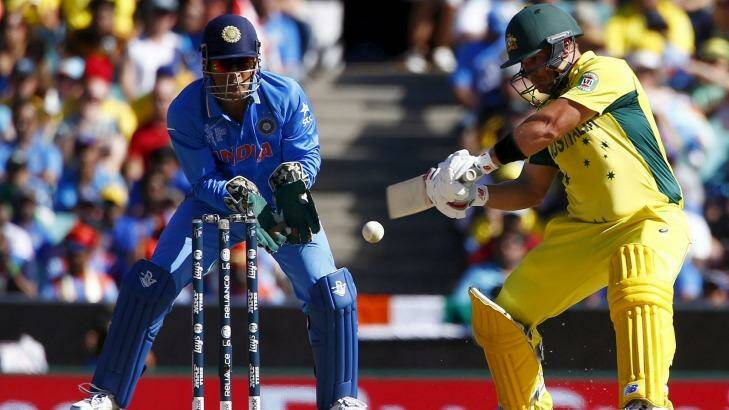 Cutting stroke: Australian batsman Aaron Finch plays a shot as India's captain MS Dhoni watches on. Photo: Reuters 