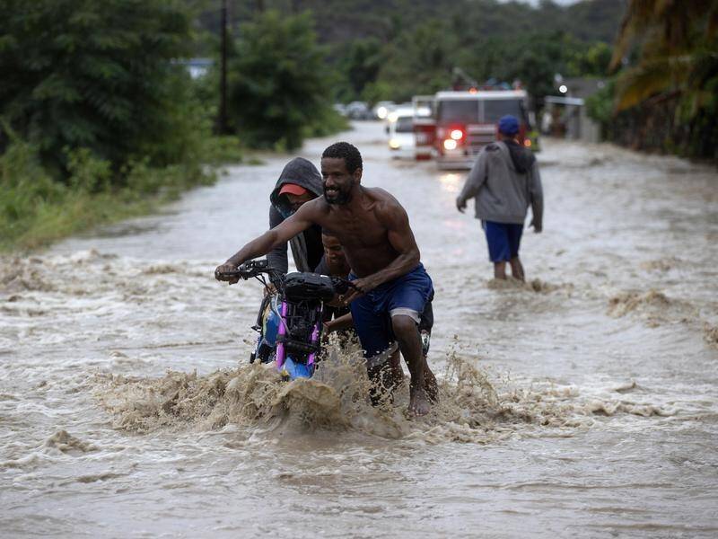 There are flood and landslide warnings in parts of the Dominican Republic after heavy rains. (EPA PHOTO)