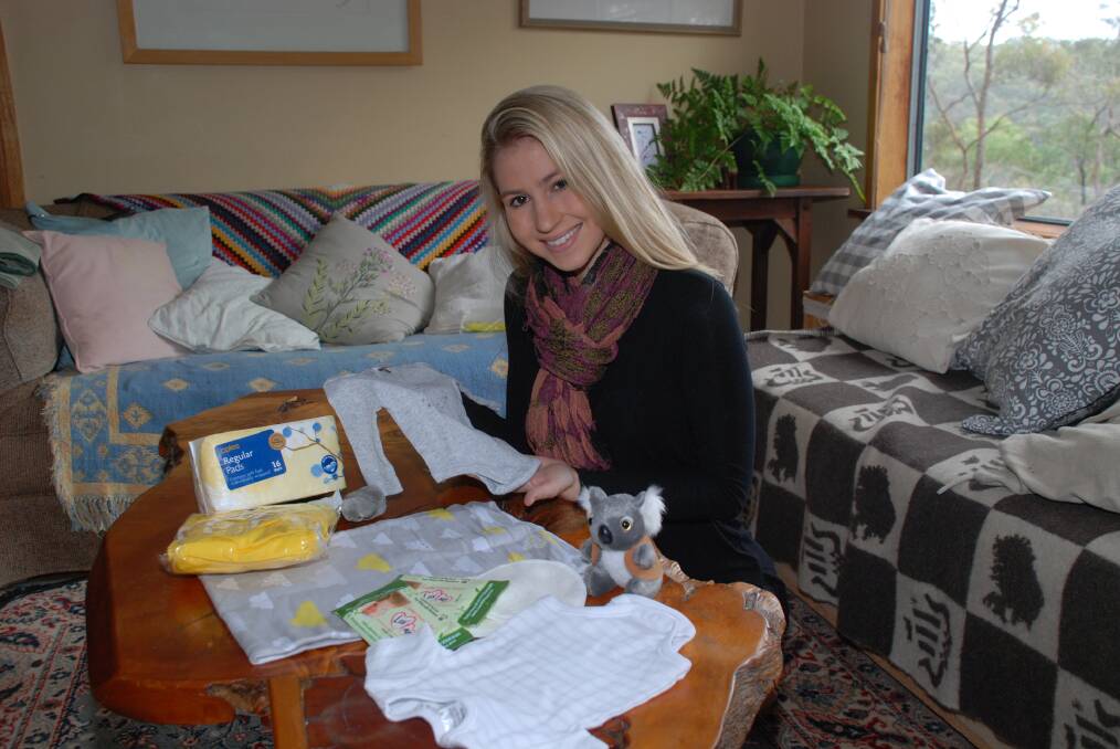 Amy Houston with the contents of one of the postnatal care packs she plans to distribute in Tanzania when she volunteers as a student midwife there in January.