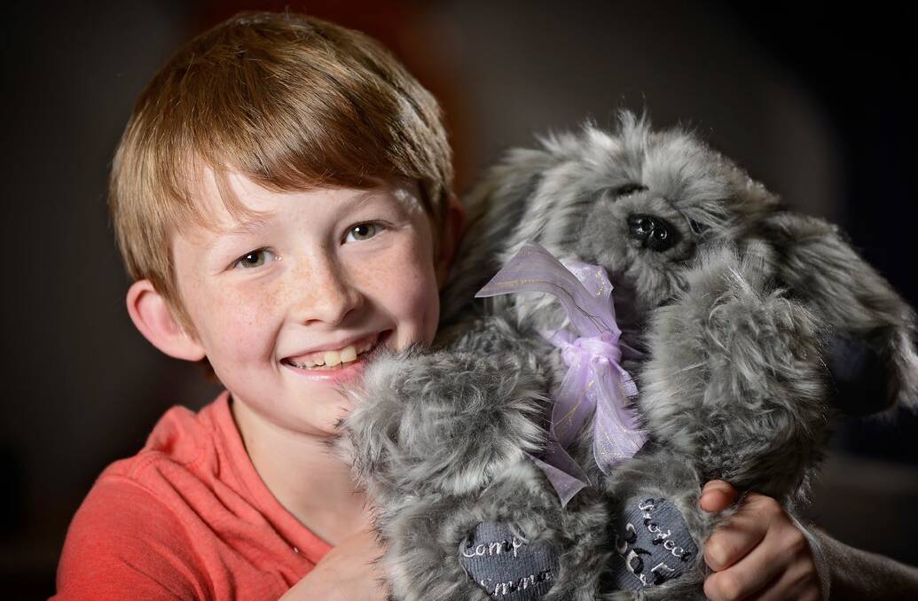 Hobart boy Campbell Remess with the teddy bear he made to send to Paris terror attack survivor Emma Parkinson, of Hobart. Picture: PHILLIP BIGGS