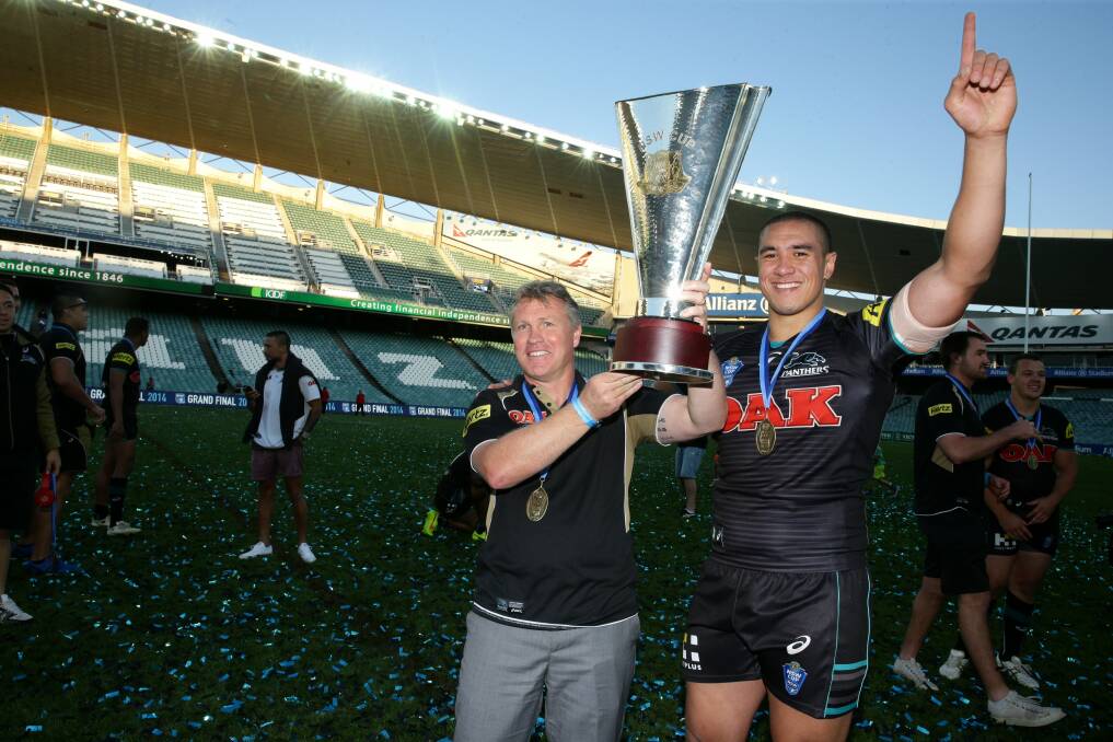 Premiership win: Leilani Latu and Penrith Panthers NSW Cup coach Garth Brennan celebrate the 2014 grand final win. Picture: Jonathan Carroll 
