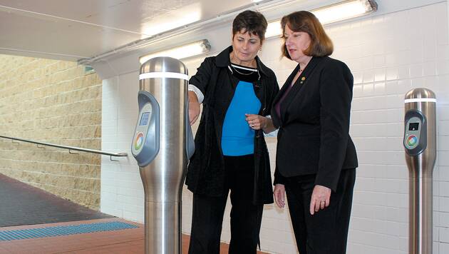 Blue Mountains MP Roza Sage (right) and commuter Annette Saling inspect the Opal ticketing system in Springwood.