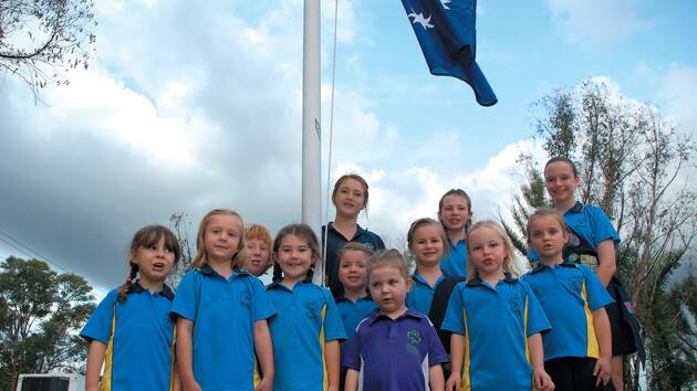 Some of the girl guides from Springwood-Winmalee district last Wednesday outside their hall on Singles Ridge Road get excited about a Royal visit.
