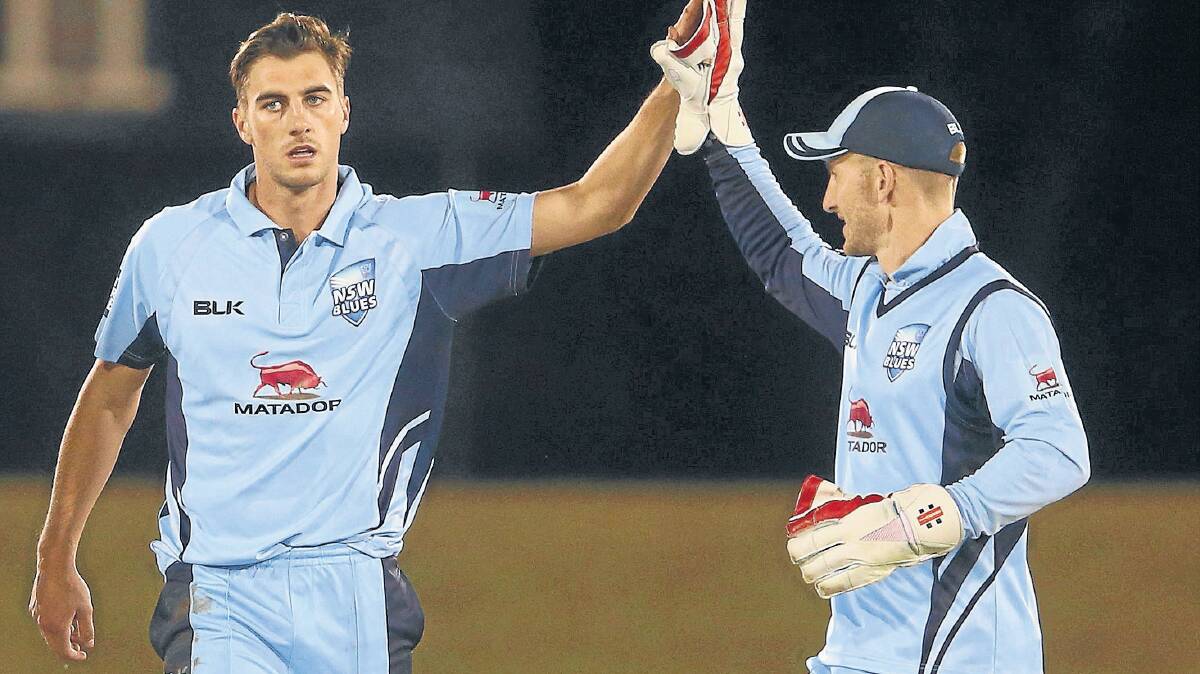 Pat Cummins (left) and Peter Nevill of the Blues celebrate the wicket of Jonathan Wells during the one day cup match between New South Wales and Tasmania at Blacktown International Sportspark on Monday night. Photo: Mark Kolbe/Getty Images.