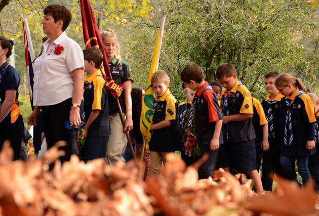 Hazelbrook Scouts stride over autumn leaves during the march to the war memorial in Gloria Park, Hazelbrook.