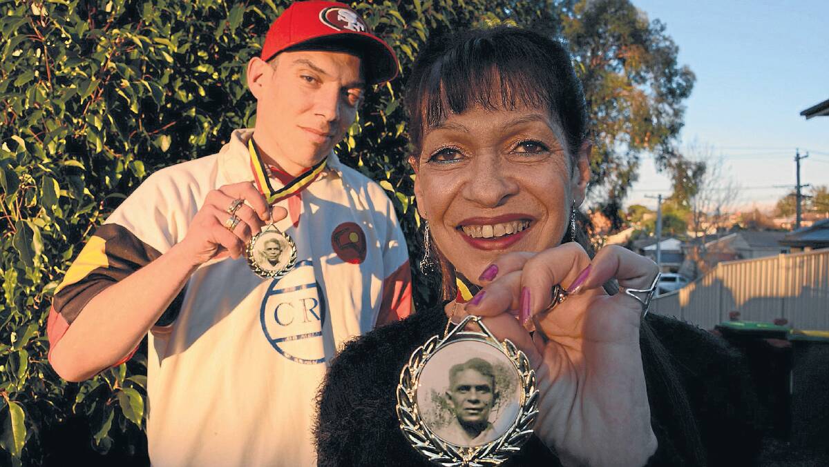 Eileen Brooks and her son, Jay, with medallions showing Jackie Brooks, Eileen's father.