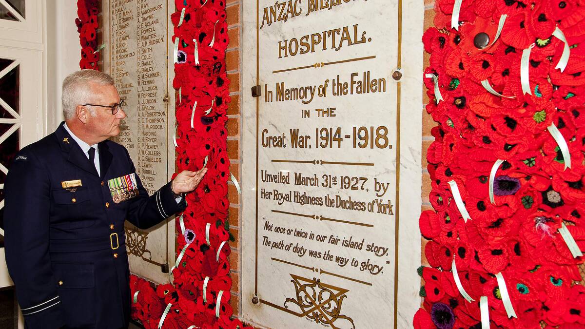 Flight Lieutenant Paul Summers views the wall of poppies at Blue Mountains Hospital in Katoomba.