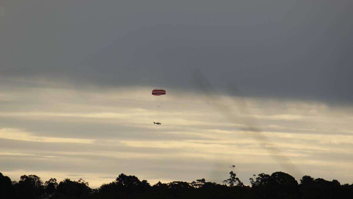 The Cirrus aircraft deploys its parachute over Lawson. Photo: Amy Davis.