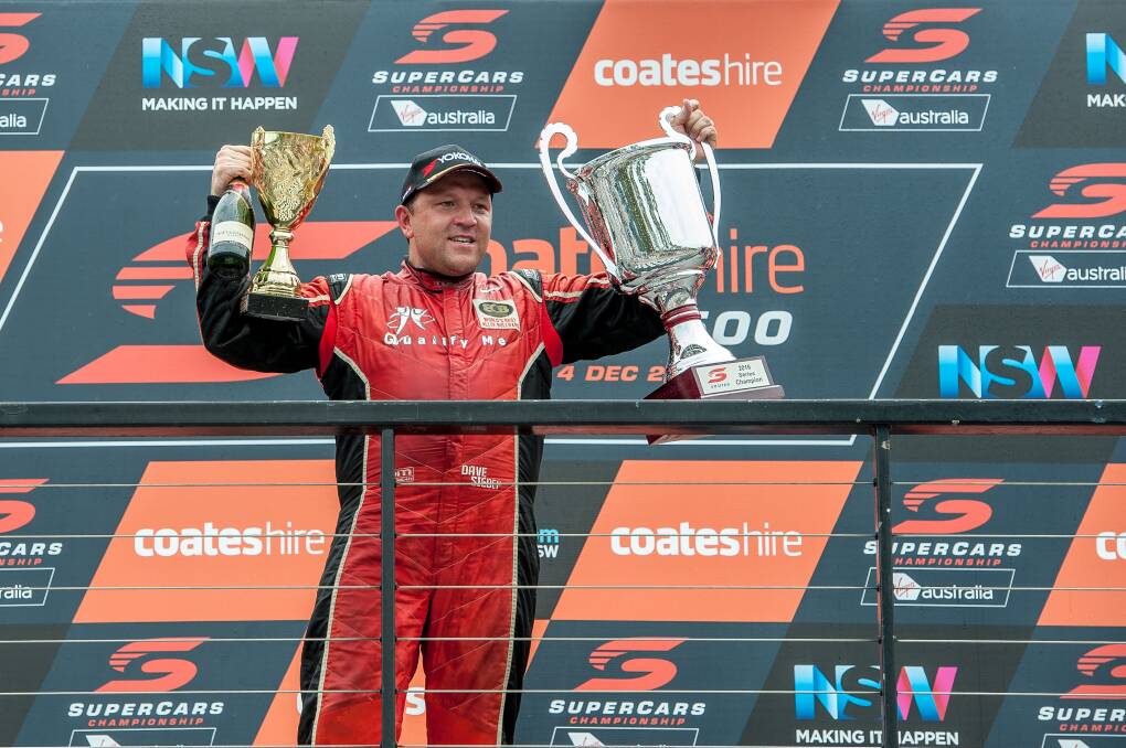 FIRED UP: David Sieders atop the podium with his V8 Utes championship trophy, and his second place trophy for the Toyota 86 series. Picture: Jeff Thomas
