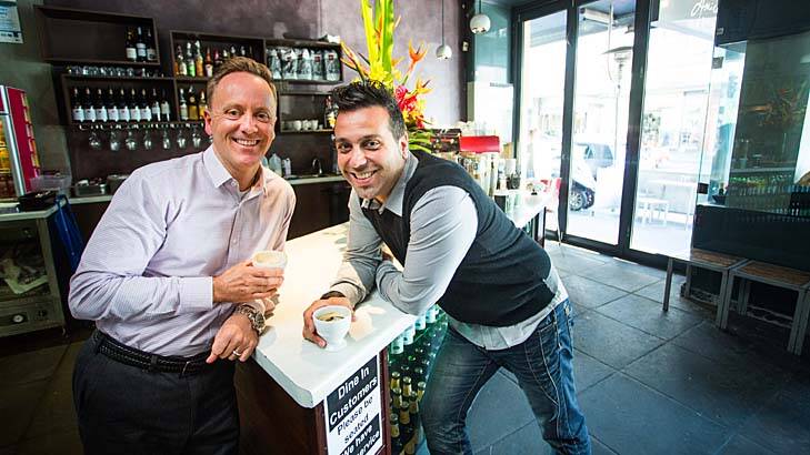 Declan Jacobs (left), a founder of the Suspended Coffee Society Melbourne, with Petros Prokopis, manager of Amici Bakery in Prahran, one of the first to get involved. Photo: James Boddington
