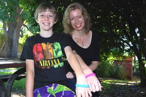 Selling point: Dylan and Michelle Forster show off their autism awareness wristbands.