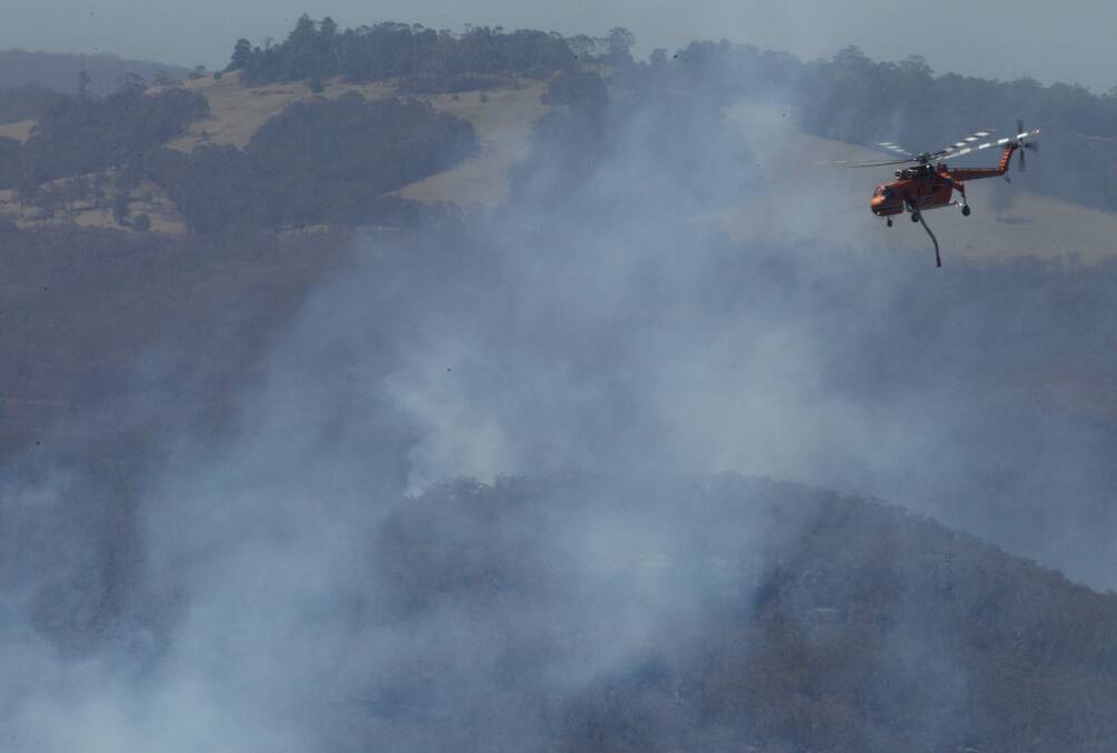 Water bombing helicopters have commenced their work on fires which have flared up around the State Mine fire near Berambing. October 23, 2013. Photo: Wolter Peeters