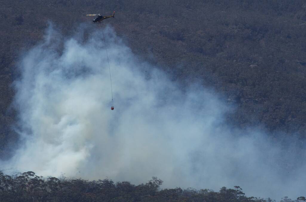 Water bombing helicopters have commenced their work on fires which have flared up around the State Mine fire near Berambing. October 23, 2013. Photo: Wolter Peeters