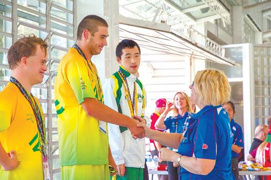 Blue Mountains-Nepean Special Olympics athlete Josh Paine-Bell receives his gold medal for winning the men's 100m backstroke final at the Special Olympics Asia-Pacific Games in Newcastle on December 3. Photo: Newcastle Sundance/Emma White