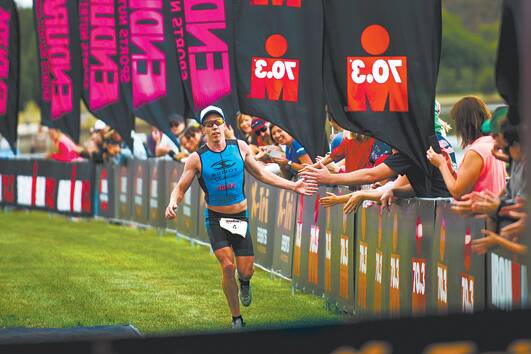 Sam Appleton finishes The Canberra Ironman 70.3 Triathlon on December 15. Photo: Rohan Thomson, The Canberra Times.
