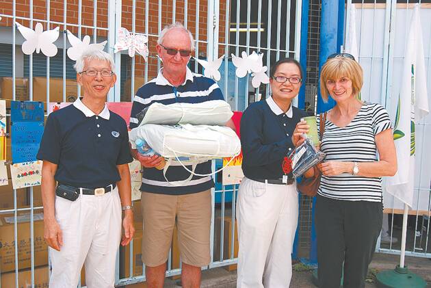 Ian and Carol Blair received their care packages from Jackson Yen and Lily Ye from the Tzu Chi Buddhist relief foundation.
