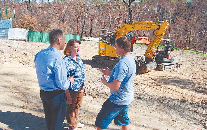 The NSW minister reponsible for the bushfire clean-up, Finance and Services Minister, Andrew Constance, and Blue Mountains MP, Roza Sage, talk with Michael Magennis on his cleaned-up property at Emma Parade, Winmalee.