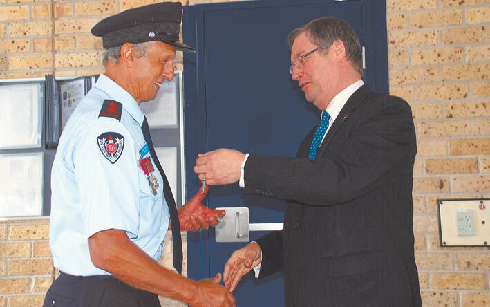Springwood Fire and Rescue On-Call Captain David Moalem accepts the keys to the fire station from Acting Minister for Police and Emergency Services Greg Smith.