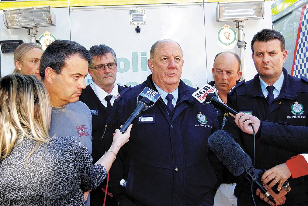  Assistant commissioner Denis Clifford addresses media last Friday over missing man Gary Tweddle. Gary's father, David, is at left; Blue Mountains local area command boss Superintendent Darryl Jobson is on the right.