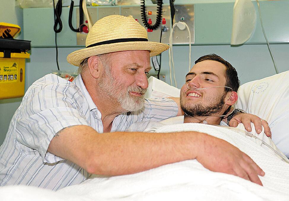 British backpacker Jamie Neale is embraced by his father Richard Cass at Katoomba Hospital on July 15, 2009.