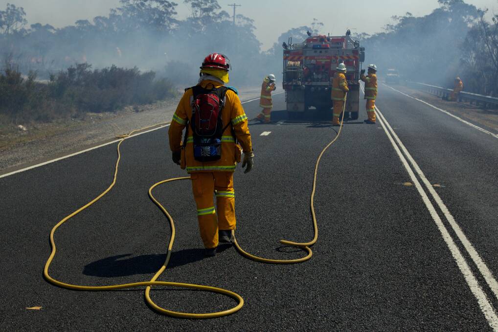 NSW RFS Crews continue to fight the State Mine fire on the Darling Causeway near Bell as they back burn onto the fire front. 21st October 2013 Photo: Wolter Peeters The Sydney Morning Herald